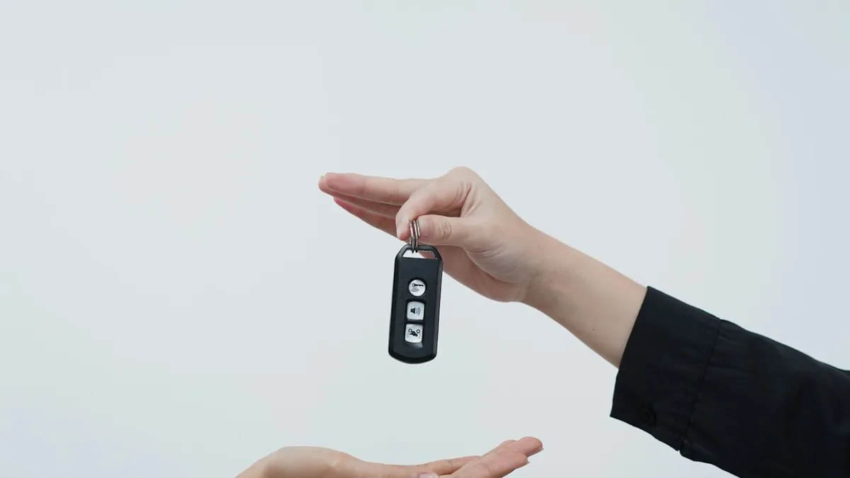 Hands exchanging a car key