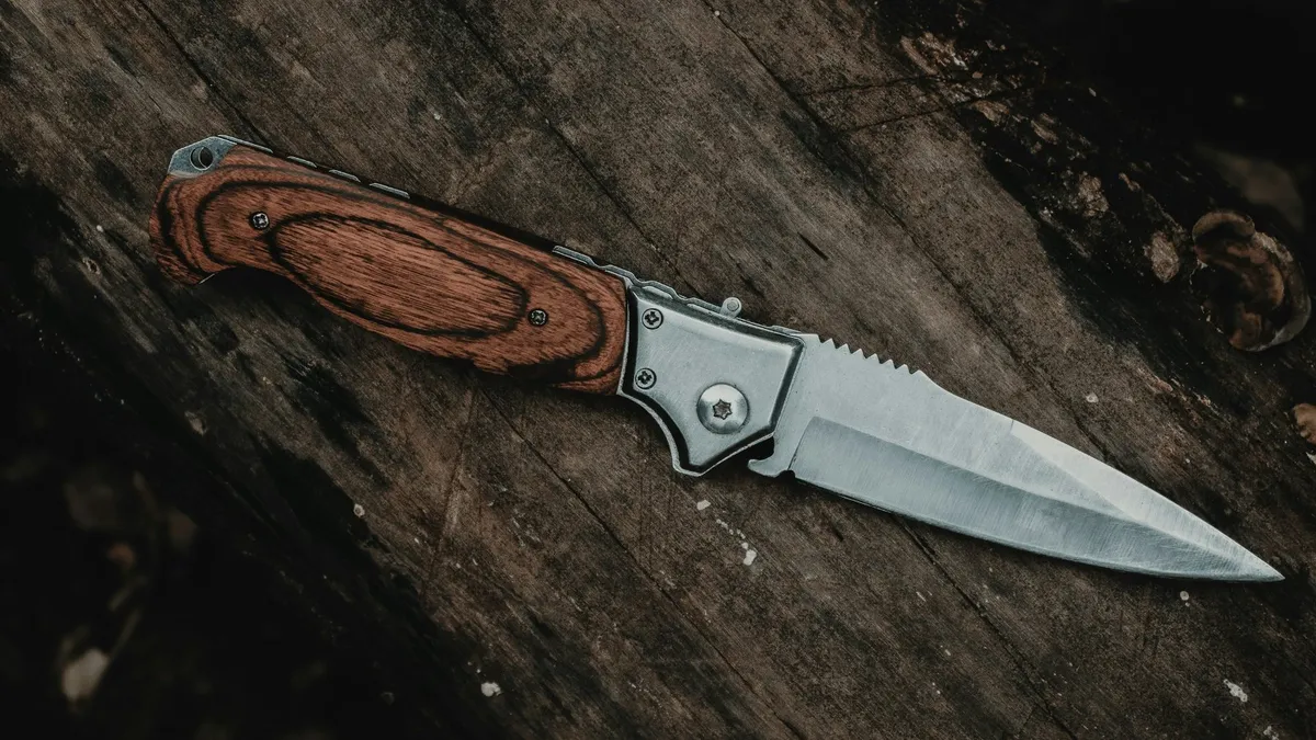 Folding pocket knife on a wooden table