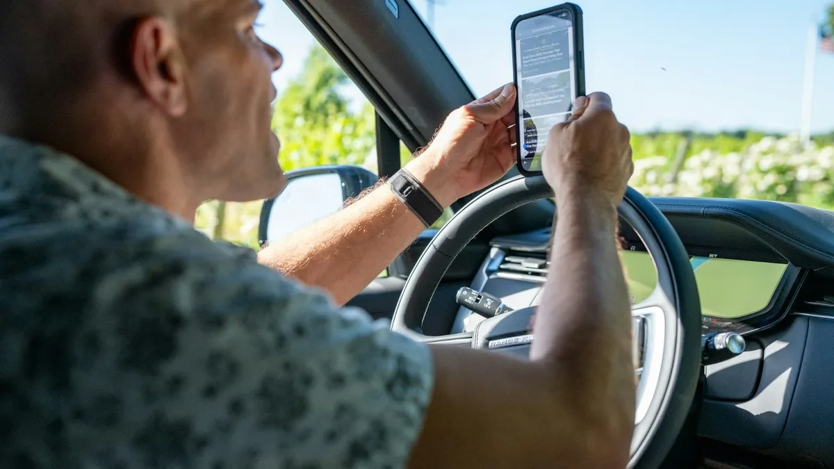 Driver holding a mobile phone while driving