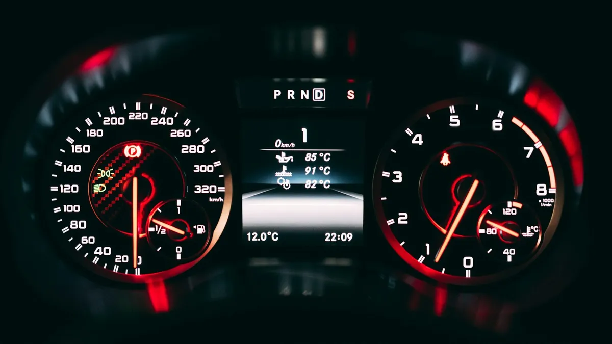 Car speedometer and dashboard lit up at night