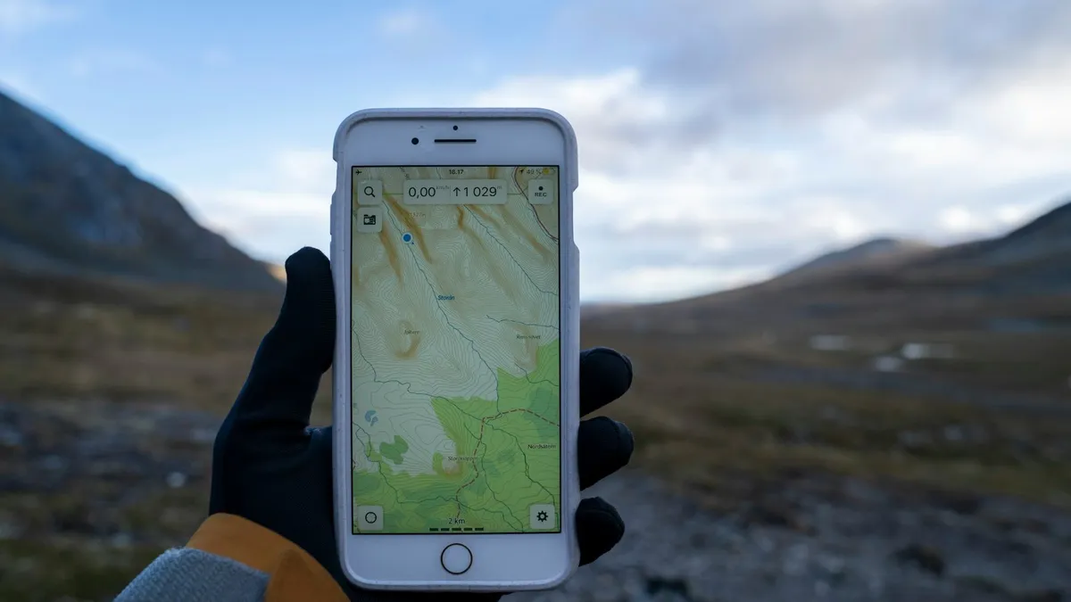 Hand holding a smartphone showing a location map